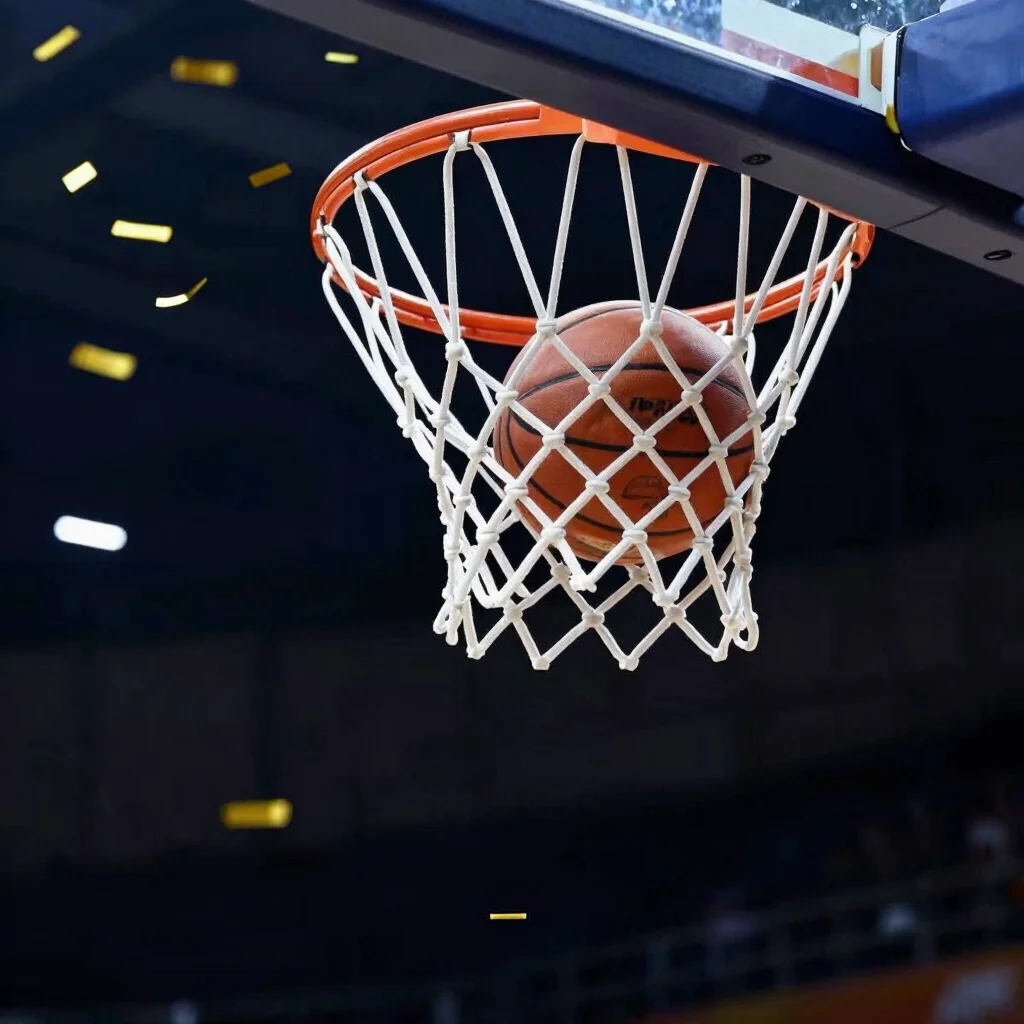 Basketball net with the ball passing through, close-up, confetti